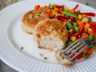 Chicken cutlets with steamed Mix vegetables, Chicken meat balls on white plate. Heathy lunch, diet food. Selective focus, close up.