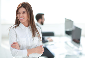 smiling business woman on the background of the workplace.