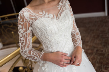 Beauty portrait of bride wearing fashion wedding dress with feathers with luxury delight make-up and hairstyle  studio indoor photo.