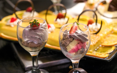 .Creams with strawberries with sweet fillings, whipped cream, sliced ​​fruit, condensed milk, fruit syrup and various ingredients