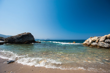 Fototapeta na wymiar Beach, Stones, sea, sand. Quiet vacation by the water.