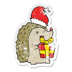distressed sticker of a cartoon hedgehog wearing christmas hat
