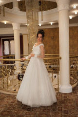 beautiful bride in chic dress. delicate bride with long hair. girl in lace dress with loop in studio Bride%27s morning in a stylish interior