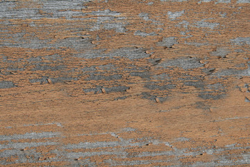 Peeling brown paint on an old wooden surface