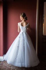 Fototapeta premium Morning of the bride when she wears a beautiful dress woman getting ready before wedding ceremony 