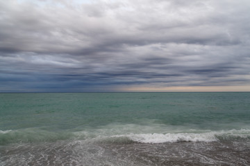 View of the sea and cloudy sky. Cloudy day on the beach. Seascape, Mediterranean.