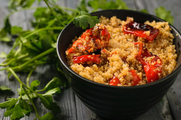 Boiled quinoa with baked vegetables on the table. Vegetarian dish.