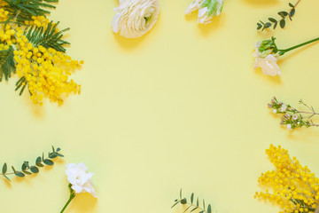 Floral spring frame with mimosas on the white background. Top view. Copy space