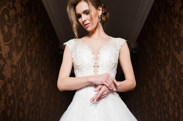 Fototapeta premium Morning of the bride when she wears a beautiful dress, woman getting ready before wedding ceremony 