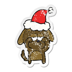 distressed sticker cartoon of a tired dog wearing santa hat