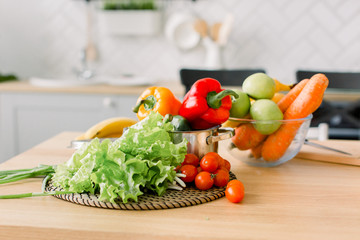 healthy foods are on the table in home kitchen. Fresh vegetables and utensils for cooking on wooden table. Healthy food, cooking concept