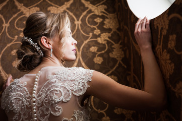 Morning of the bride when she wears a beautiful dress, woman getting ready before wedding ceremony 