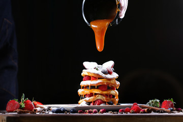 Thick caramel flows onto a freshly prepared package. Beautiful dessert serving in a restaurant or cafe.