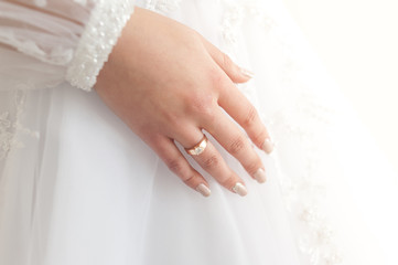Beautiful bride wearing fashion wedding dress with feathers with luxury delight make-up and hairstyle  studio indoor photo shoot