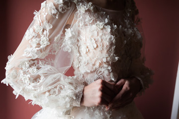 Beautiful bride wearing fashion wedding dress with feathers with luxury delight make-up and hairstyle, studio indoor photo shoot