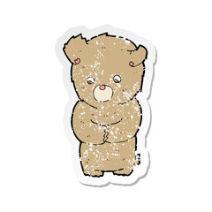 retro distressed sticker of a cartoon shy teddy bear