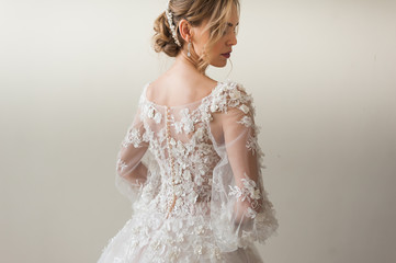Beautiful bride wearing fashion wedding dress with feathers with luxury delight make-up and...