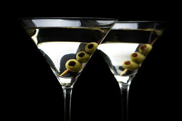 Close up Martini cocktails with olives isolated on black