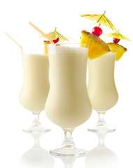 Cropped view Pina colada drinks with sunshade isolated on white