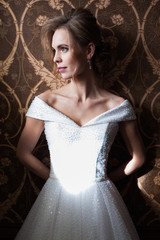 Bride.Young fashion model with perfect skin and make up  brown background  curly hair