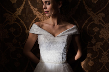 Bride.Young fashion model with perfect skin and make up  brown background  curly hair