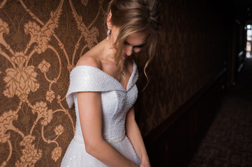 Bride.Young fashion model with perfect skin and make up  brown background  curly hair