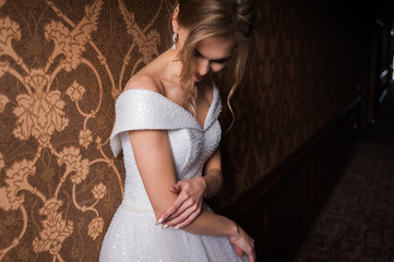 Bride.Young fashion model with perfect skin and make up  brown background  curly hair