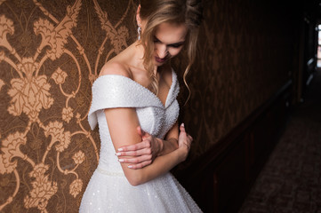 Bride.Young fashion model with perfect skin and make up  brown background  curly hair