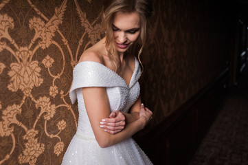 Bride.Young fashion model with perfect skin and make up  brown background  curly hair