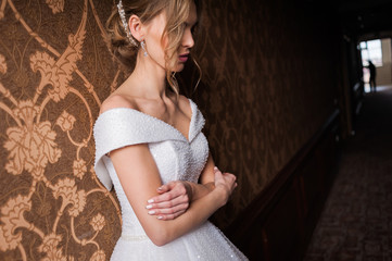 Bride.Young fashion model with perfect skin and make up  brown background  curly hair