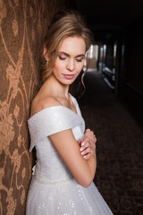 Bride.Young fashion model with perfect skin and make up  brown background  curly hair