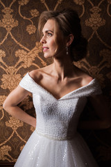 Bride.Young fashion model with perfect skin and make up  brown background  curly hair