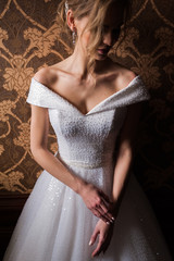 Bride.Young fashion model with perfect skin and make up  brown background  curly hair