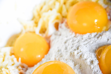 raw yolks lie on white flour cooking spices top view abstraction