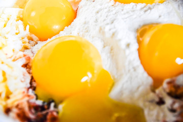 raw yolks lie on white flour cooking spices top view abstraction