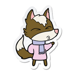 sticker of a cartoon wolf in winter clothes