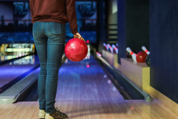 Woman in club for bowling is throwing ball