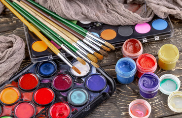 Paint brushes and paints for drawing.