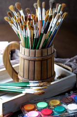 Paint brushes and paints for drawing.