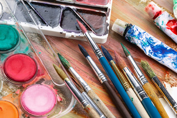 Paint brushes and paints for drawing.