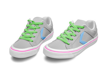 Colorful female sneakers on a white background with green shoelace and pink line