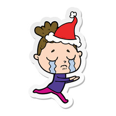 sticker cartoon of a crying woman wearing santa hat