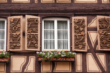 Fototapeta na wymiar Colmar, France - May 27, 2012: A baker window decorated with baking products on a traditional half timbered house, Colmar, France