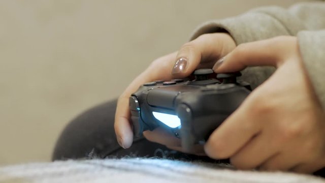 Woman play on video game, close up of hands and joystick 
