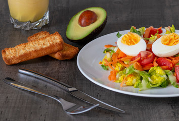 beautiful fresh light salad with vegetables on a wooden table