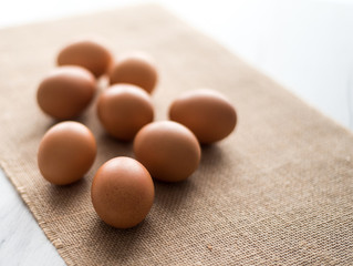  Fresh eggs in wicker basket  on wood table Prepare chicken eggs and egg whisk for cooking or bakery can use for background or wallpaper.