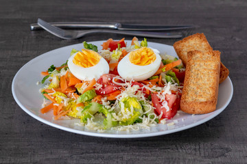 beautiful fresh light salad with vegetables on a wooden table