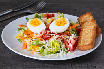 beautiful fresh light salad with vegetables on a wooden table