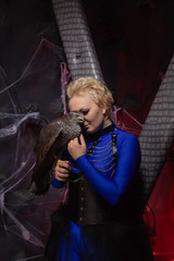 beautiful scary woman with the big hawk best friend on the background of dark room