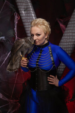 beautiful scary woman with the big hawk best friend on the background of dark room